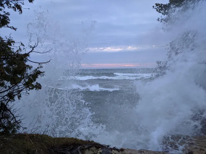 Waves from Lake Michigan batter the shore at Cave Point County Park in Door County, WI